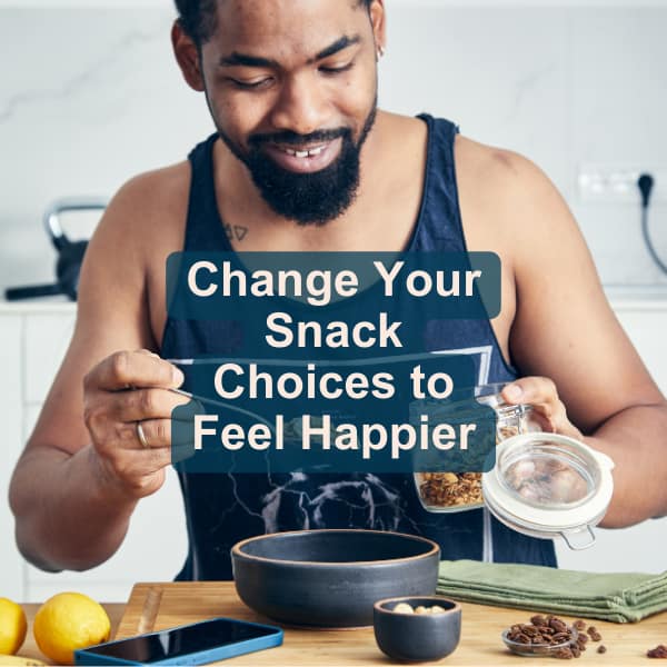 man eating snacks says “change your snack choices to feel happier"